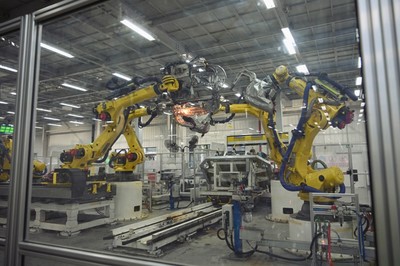 12月1日,沙坪坝区赛力斯汽车智慧工厂,机器人正有序协作,激光焊接高速运转。